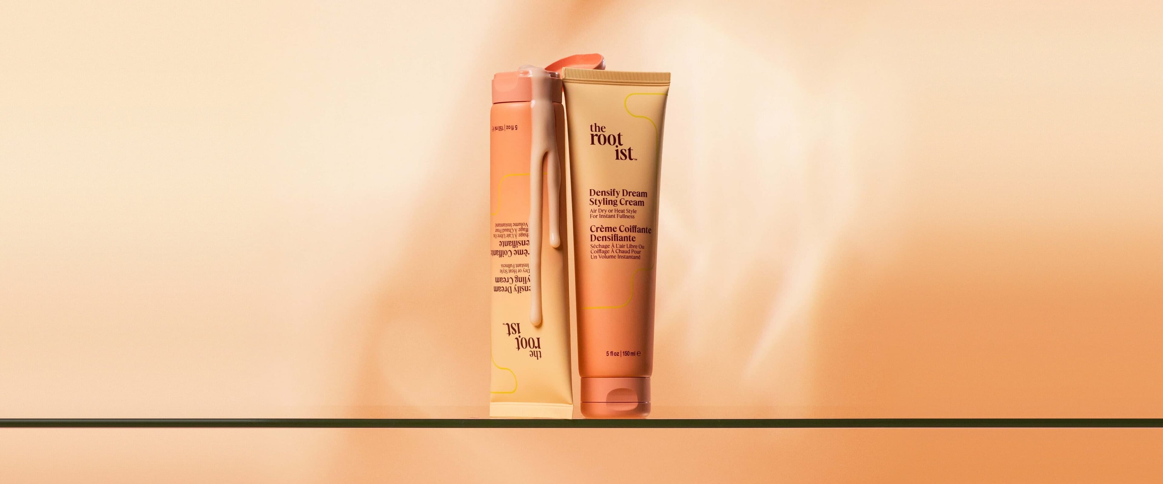Densify Dream Styling Cream tubes on a glass shelf